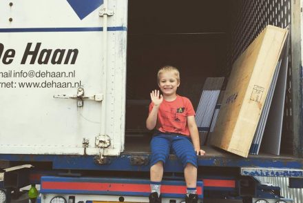 Child waving from back of lorry